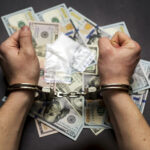 Man In Handcuffs With Money And Drugs On Dark Background The Co